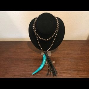 Gray bead necklace with horn